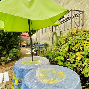 a table with a green umbrella