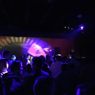 a crowd of people in a dark room