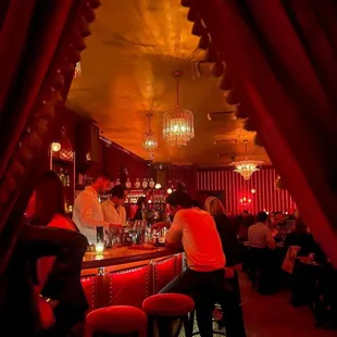 a group of people sitting at a bar