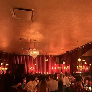 a group of people sitting at tables in a restaurant