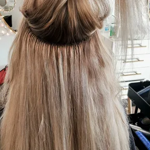 under the seams of hair extensions