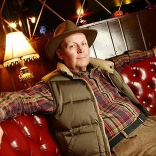 a man sitting on a red couch