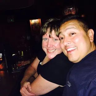 two people sitting at a bar