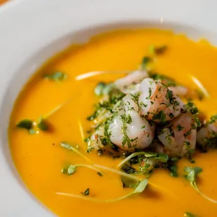 a bowl of soup with shrimp