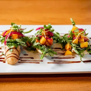 an appetizer of grilled peaches and arugula