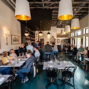 a busy dining room with people sitting at tables