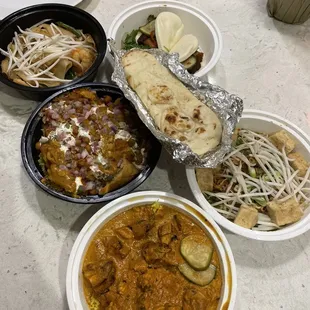 (Left) Drunken Noodles (Shrimp), Samosa Chaat, butter chicken. (Right) Gua bao, Garlic noodles with tofu, S/O Naan