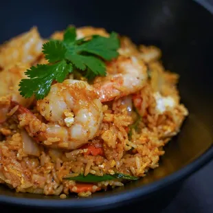 a bowl of rice with shrimp and vegetables