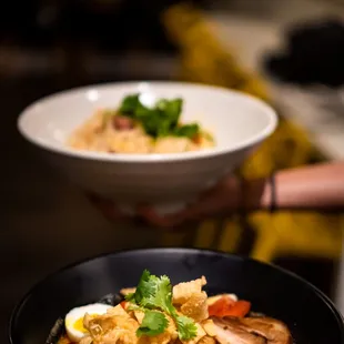 two bowls of food being served