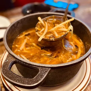 a bowl of soup with a ladle