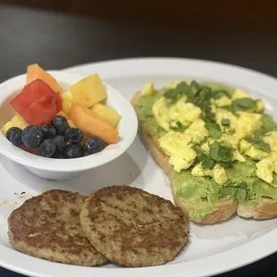 Avocado toast with turkey sausage and fruit on the side.
