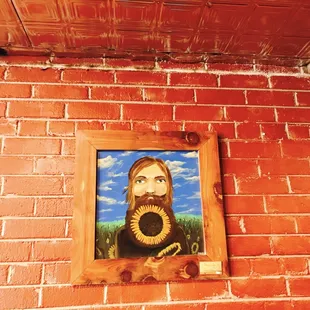 a brick wall with a painting of a woman with a gas mask