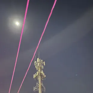 a cell tower and a full moon