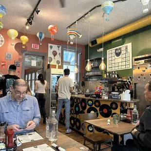 people sitting at tables in a restaurant