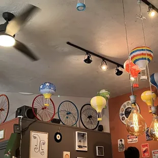 a variety of colorful balloons hanging from the ceiling