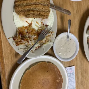 Chicken fried steak breakfast with two eggs, hash brown or grits and a pancake or toast. Best chicken fried steak I&apos;ve had in a long time.