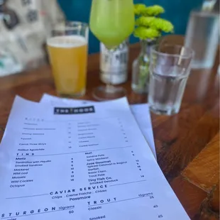 a menu and drinks on a table
