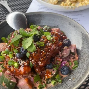 Korean Fried Chicken with kimchi and cucumber slaw and pickled blueberries.