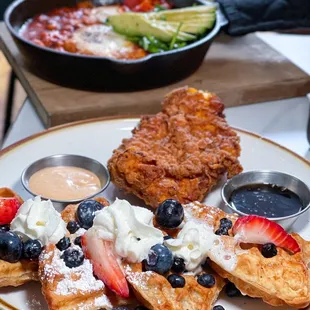 a plate of waffles and fruit