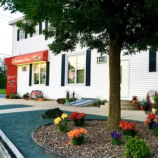 a flower bed in front of the house