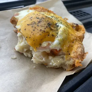 a breakfast sandwich on a piece of paper