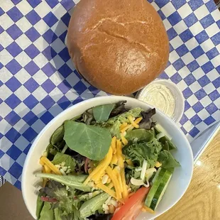 Mushroom &amp; Swiss burger and side salad with Caesar dressing.