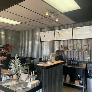 a restaurant counter with people working behind it