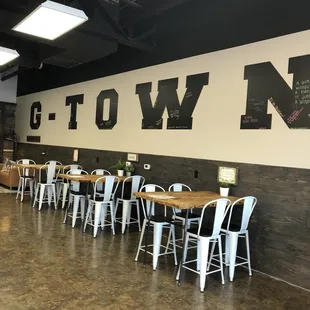 the interior of a restaurant with tables and chairs