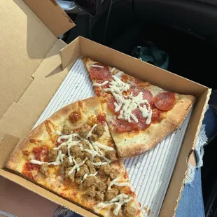 Two slices of pie - pepperoni and sausage.