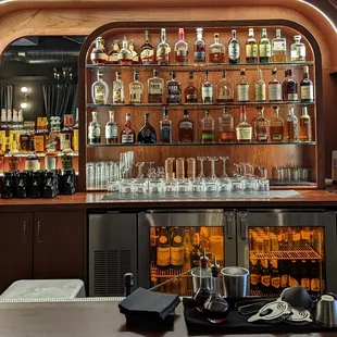 a bar with liquor bottles and glasses