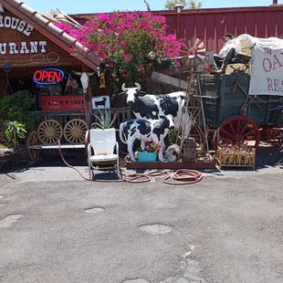 a horse drawn wagon and a cow statue