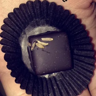 a hand holding a piece of chocolate