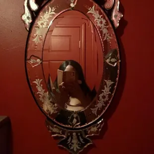 I&apos;m feeling the red walls and vintage mirror in the bathroom lol