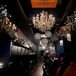 the interior of a restaurant with a chandelier hanging from the ceiling