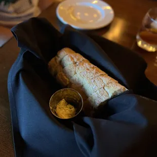 a sandwich wrapped in a black cloth