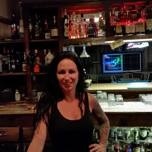 a woman standing in front of the bar