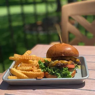 Enjoying the NEW Summer feature Green Chili Burger on the deck at The Oaks
