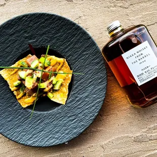 a plate of nachos and a bottle of maple syrup