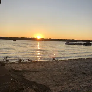 the sun setting over the water