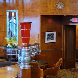 a red vase on a pedestal