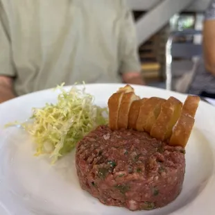 a man sitting at a table with a plate of food
