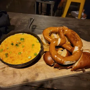 two pretzels and a bowl of soup