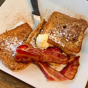a plate of french toast and bacon