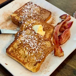 a plate of french toast and bacon