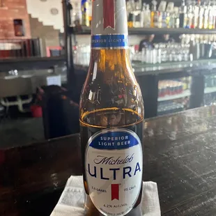 a bottle of ultra beer on a napkin