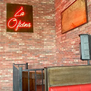 a brick wall with a neon sign