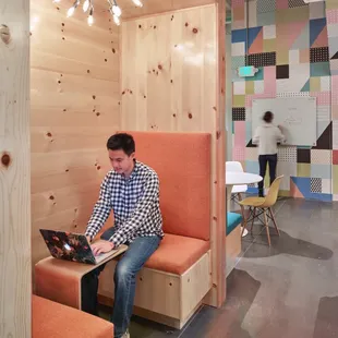 Knotty pine nooks for casual meetings &amp; quiet work.
