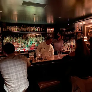 a group of people sitting at a bar