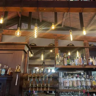 a bar with a lot of bottles on the shelves