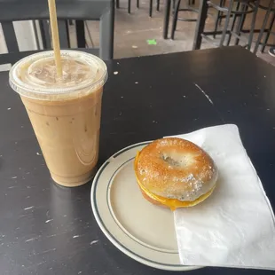 Vanilla Oat Milk Latte and Everything Bagel sandwich with egg, cheese, and bacon made by the lovely Payton